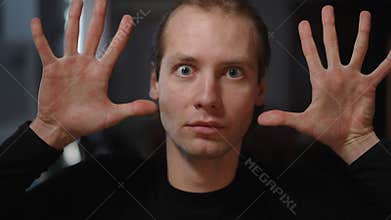Expressive Portraits Featuring a Young Man with His Hands Raised Up High in Joyful Energy