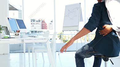 Girl pushing her co worker on a swivel chair