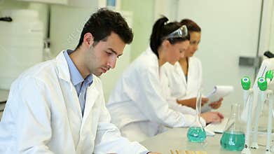 Chemistry students working on an experiment together