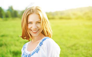 Happy beautiful young woman laughing and smiling on nature
