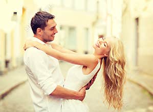 Smiling couple dancing in the city