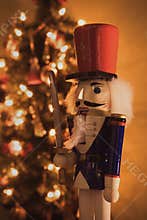 Photo of a wooden soldier in front of the Christmas tree lights