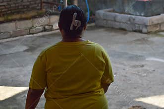 A woman walking to the backyard chicken coop early morning