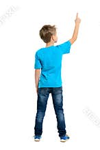 Rear view of a school boy over white background pointing upwards