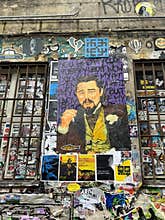 A street art poster depicting leonardo dicaprio as django unchained\'s calvin candie is pasted on