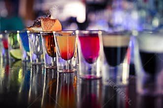 Shots with liquor and alcohol in cocktail bar