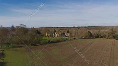 Aerial view of old manor house, stately home with Victorian era architecture and large green landscape