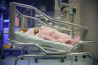 Baby in an incubator sleeping