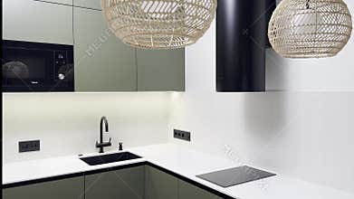 Modern kitchen interior with olive green MDF cabinets and built