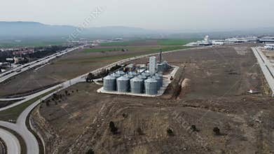 Aerial view of farm grain silo in wide agricultural field