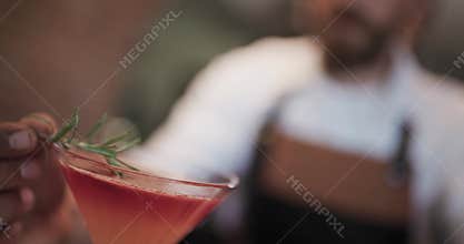 Create a refreshing cocktail with a barman in a