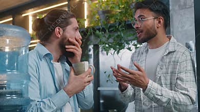 Two diversity men casual business team coworkers talking break pause in office cafe Arabian man talking news Caucasian