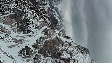 Rocky snow mountains and clouds