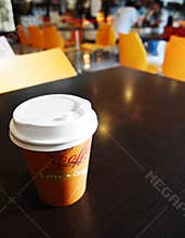 Coffee takeout cup on campus cafe table