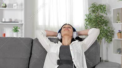 Woman listening to music relaxing on a couch