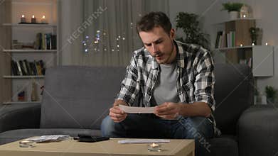 Serious man accounting checking receipts