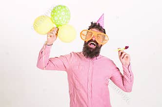 Surprise concept. Man with beard and mustache on surprised face holds air balloons, white background. Hipster in giant