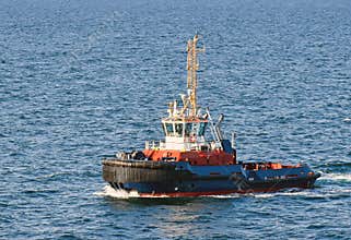 A tugboat navigates on the sea