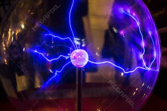 Plasma ball with smooth magenta-blue flames on a dark background.