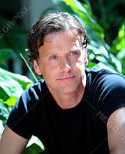 Handsome middle aged man looking pensive in the sun