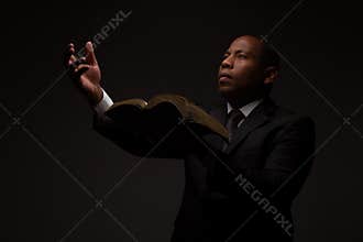 African American Christian Man with the Scriptures in Hand Making an Appeal