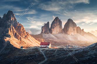 Mountain valley with beautiful house and church at sunset