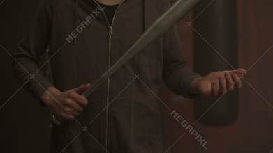 Midsection of violent hooligan holding baseball bat