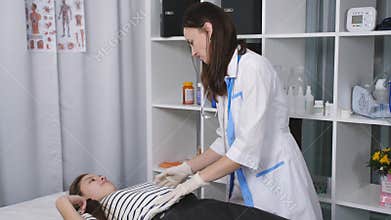 Female doctor makes teen girl massage in the clinic office