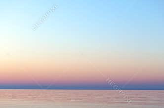 Clear sunset sky. Gradient background in pastel colors. Sunset over the sea.