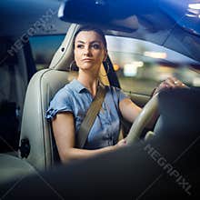 Pretty, young woman driving a car