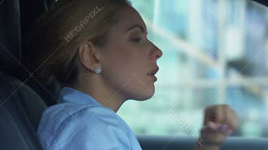 Disappointed businesswoman takes off glasses, sitting in car, upset with failure