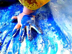 Closeup of children hands painting during a school activity - learning by doing, education and art, art therapy concept