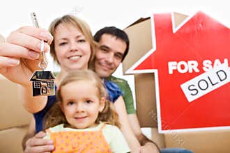 Happy new homeowners - family moving concept