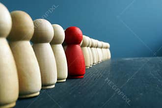 Leadership development. Line of wooden figurines with red one