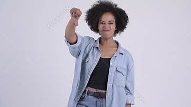 Young angry African woman giving thumbs down