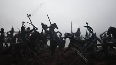 Medieval battle scene with cavalry and infantry. Silhouettes of figures as separate objects, fight between warriors on sunset