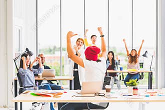 Multiethnic diverse group of creative team or business coworker celebrate together in modern office. Success teamwork concept