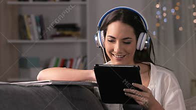 Happy student e-learning with tablet and notebook