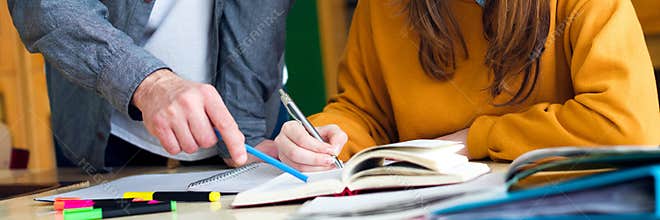 Young teacher helping his student in chemistry class. Education, Tutoring and Encouragement concept.