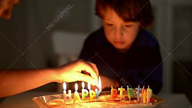Happy Kid Blowing Candles at his Anniversary