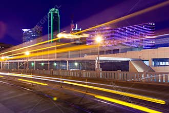 Light trails from moving streetcar on the Houston Street with the city of Dallas in background