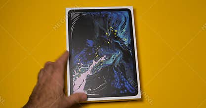Man arranging on table latest iPad Pro smart tablet