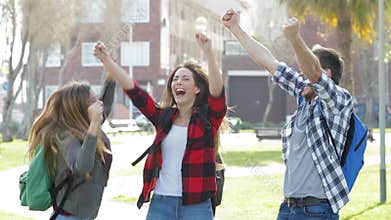 Excited students jumping celebrating good news