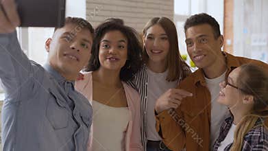 Say hello! mixed race group of 5 people. Cheerful people talking on a cell phone camera. teens laugh and say hi to the