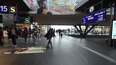 Berlin, Germany, 08 May 2019: Passengers at train station. Group of people with their luggage walking on busy airport terminal. Cr