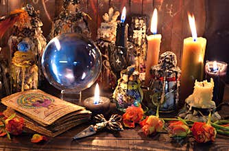 Tarot cards, burning candles, witch magic bottles and crystal ball