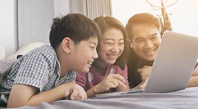 Happy family Father mother and son watching on laptop computer