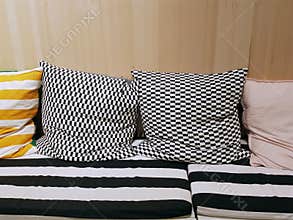 Cushioning Seats with Patterned Pillows Against Wooden Wall on the Back