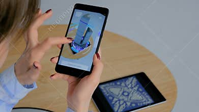 Woman using smartphone with architectural augmented reality app