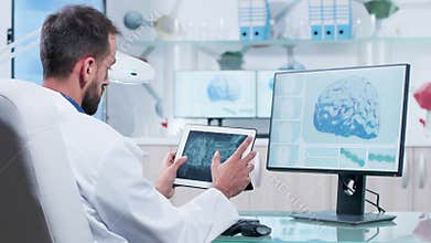 In modern research facility doctor is looking at X ray scans